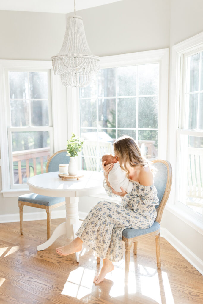 In home newborn session with mom and baby snuggling in kitchen